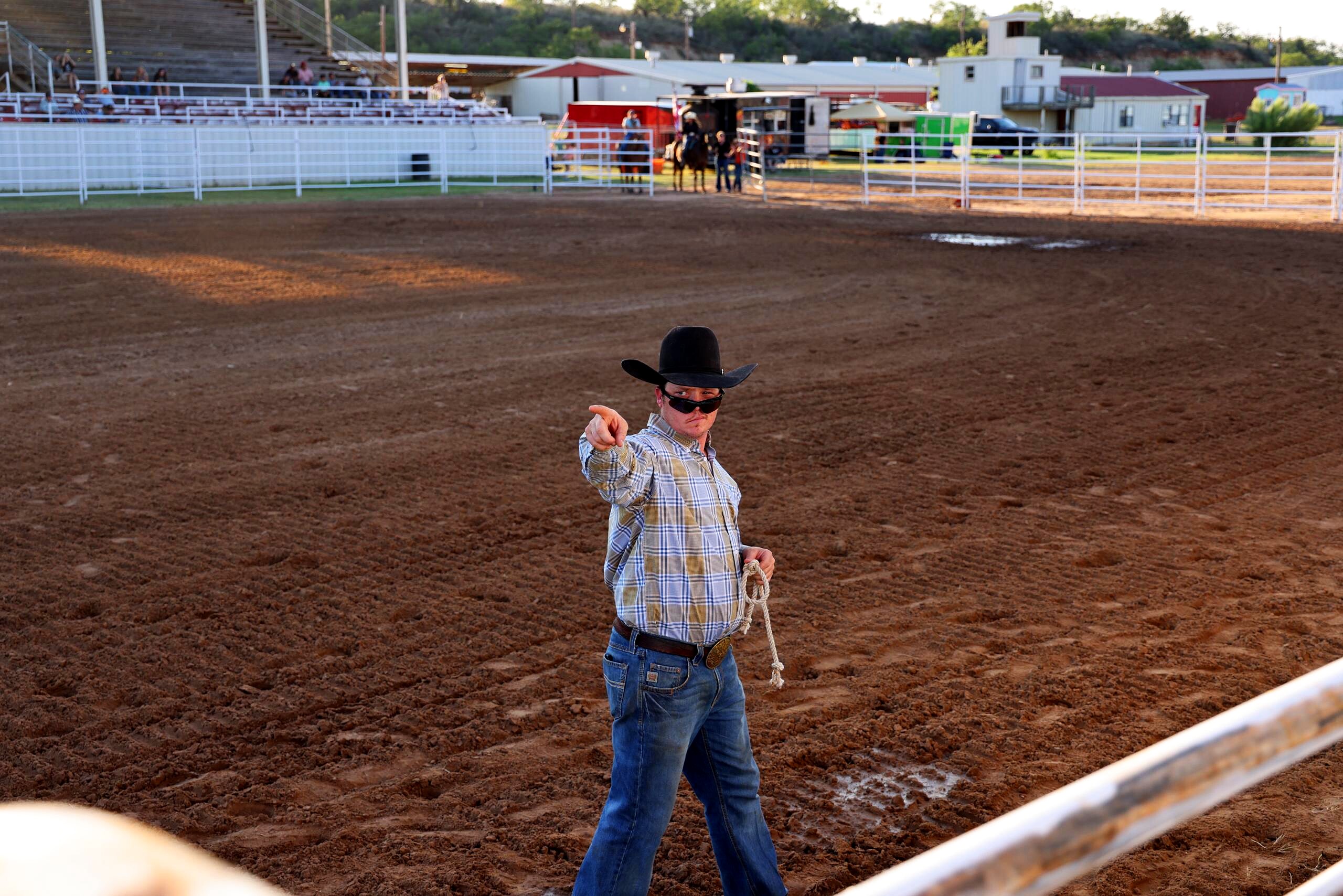 Cowboy directing activity from inside the rodeo arena